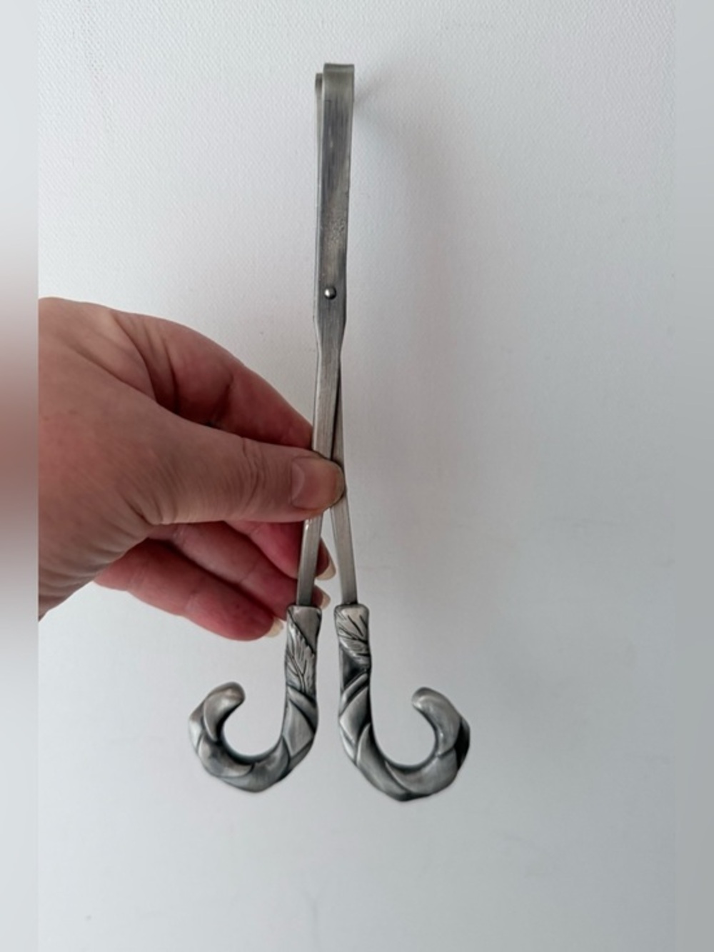 vintage pewter wick trimmer featuring a detailed repoussé leaf design